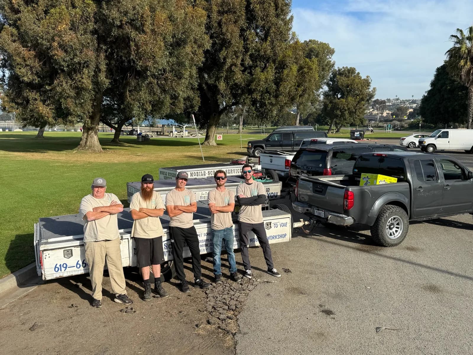 San Diego Mobile Screens full team standing in front of mobile workshop trailers