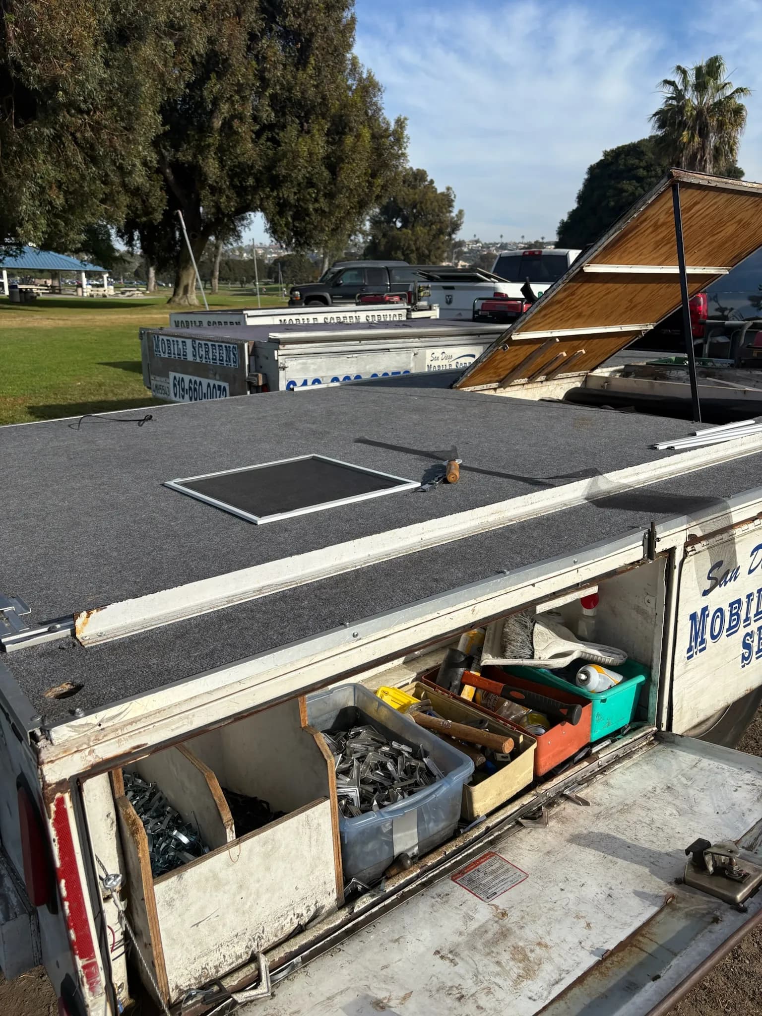 Our mobile workshop trailer with its workbench up and bins of parts and tools
