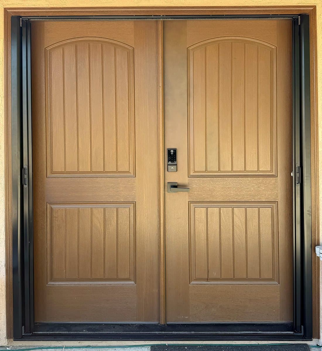 The same brown double front door with the retractable screens rolled away out of sight